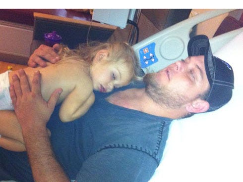 Kevin Mayberry embraces his daughter, Layla, 2, who is receiving treatments for acute lymphoblast leukemia.