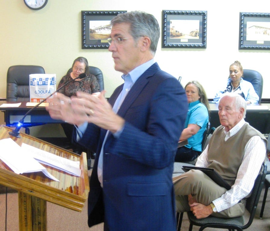 Allen Turner, owner of Crestview's Chevrolet dealership, speaks in favor of an itinerant vendor ordinance. Bob Lee, owner of the city's Chrysler dealership, sits behind him and also spoke in favor of the proposal.