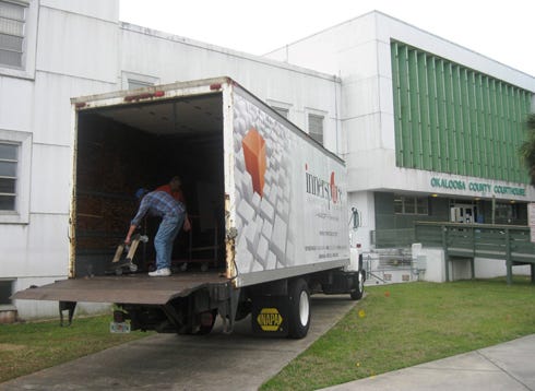 Movers prepare to relocate furniture and equipment from the Clerk of Circuit Court's offices in the current Okaloosa County Courthouse to their temporary location in the former county hospital.