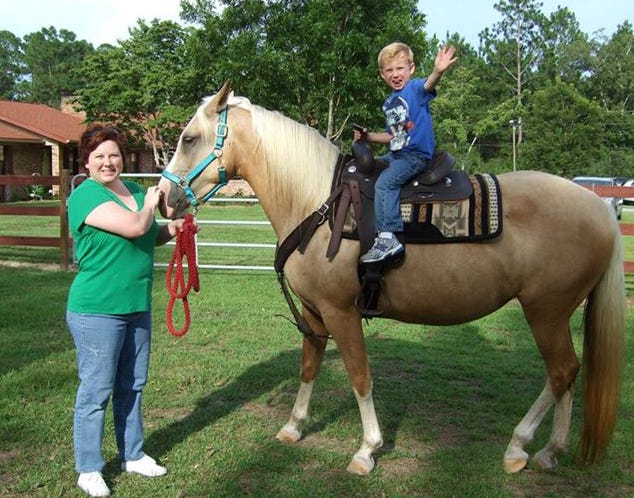 Zachary Mann rides a horse directed by his mother, Dawn Mann, at Old Warrior Ranch in Crestview. "Be a Cowboy or Cowgirl for a Day," a Crestview YMCA fundraiser, is Sunday, Sept. 29 at the ranch.