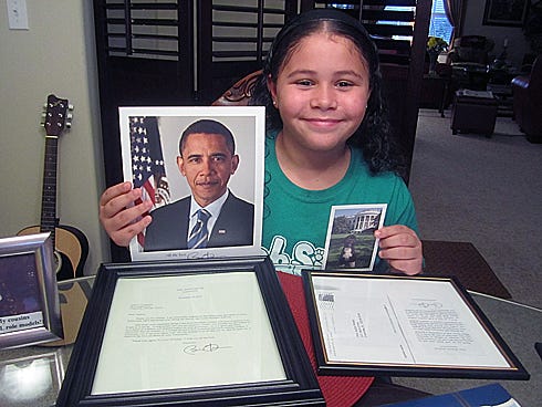 Justice Livingston, 9, shows materials she received after writing a letter to President Barack Obama. They include a photo of the president, a letter and a photo of Bo, the first dog.