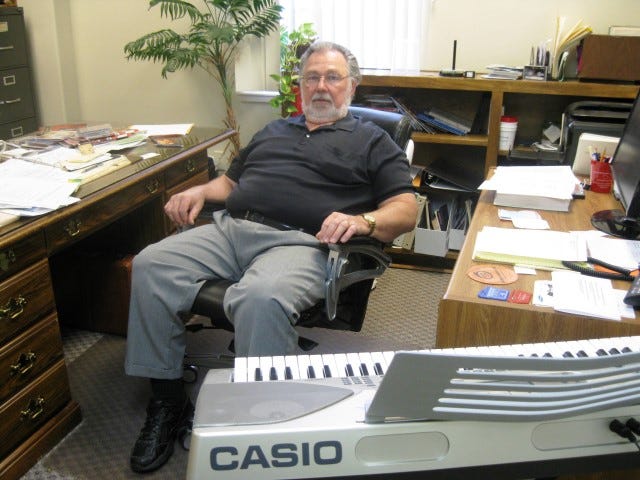 Paul Conrad sits amid the clutter of 25 years of service to First Baptist Church of Crestview as he packs his office upon retirement. “I’m trying to decide what needs to go and what needs to stay,” he said.