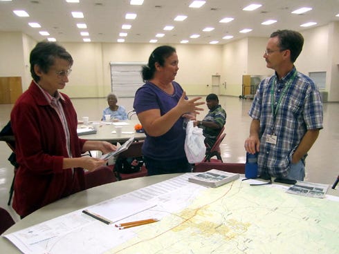 Residents Ruthie Blocker and Lisa Baughman discuss Crestview bus service with Ted Scholl of Okaloosa County Transit during a public bus workshop Tuesday afternoon.