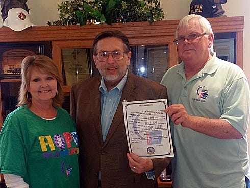 2015 Relay For Life committee members Melanie Fullerton — standing in for 2015 chair Megan Bowersox — and Loney Whitley flank Crestview Mayor David Cadle. April 20-25, 2015 is American Cancer Society Relay For Life Week by Cadle's proclamation.