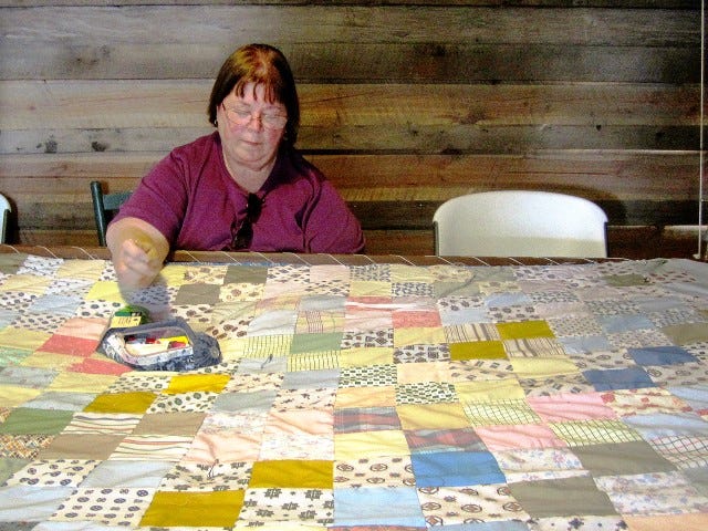 Fabric artist Mary Richardson, shown working a traditional quilt, invites north county artists, artisans and crafters to a March 20 organizational meeting at Journey Java Connection that could lead to the creation of an area arts guild.
