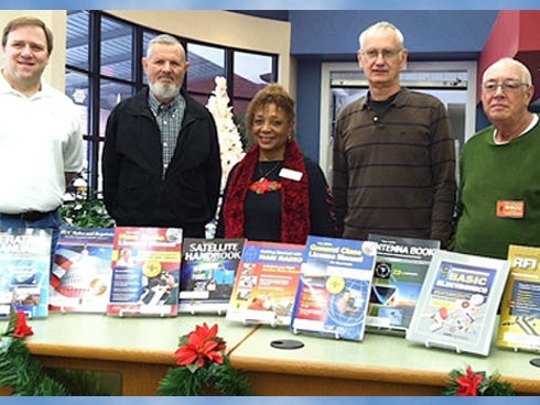 North Okaloosa Amateur Radio Club members present a set of amateur radio training books to Crestview Public Library Director Jean Lewis, center. From left are Ron Mahn, training director, Bob Sullivan, Mike Martel and President Bob Walker.