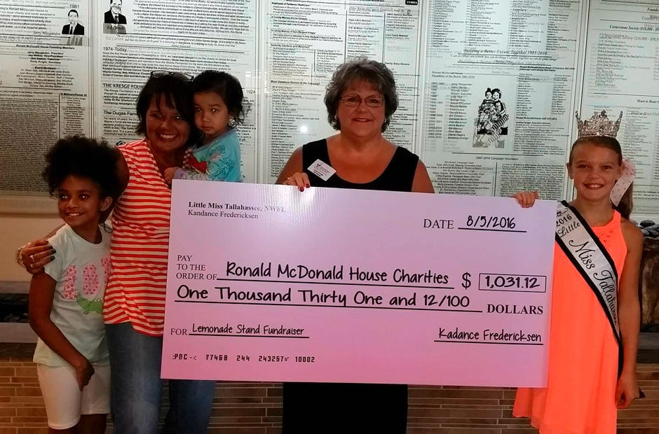 Siblings of a sick child receiving care at the Ronald McDonald House in Pensacola flank Summer Jimmerson, the nonprofit organization's local development director, 
Cindy Cornett, RMH's Family Services Manager, and Kadance Fredericksen, Little Miss Tallashassee Northwest Florida, hold a check for $1,031.12.