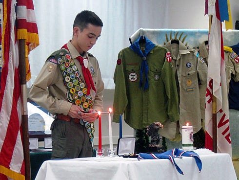 Austin Carrico — lighting candles that symbolize the Scout Oath's three components: duty to God and country, to other people, and to himself — is Crestview's newest Eagle Scout.