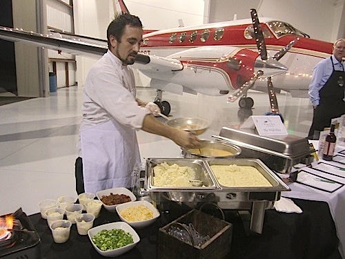Chef Joe Sanchez of the Wild Olive prepares sautéed shrimp served over smoked gouda cheese grits, a menu selection that proved one of the Wine Gala's most popular.