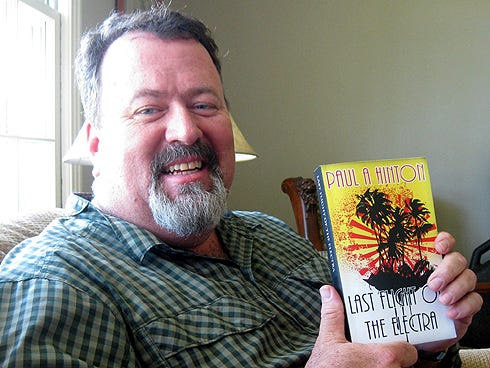Crestview author Paul Hinton displays his first, recently published novel, "Last Flight of the Electra."