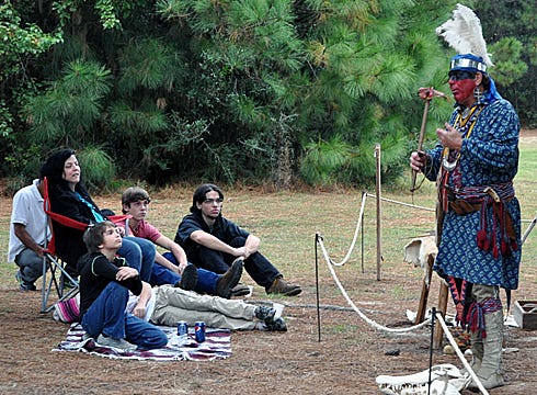 Ferris "Blue Heron" Powell displays a tool that Creek Indians used during a presentation Saturday at the Crestview Public Library.