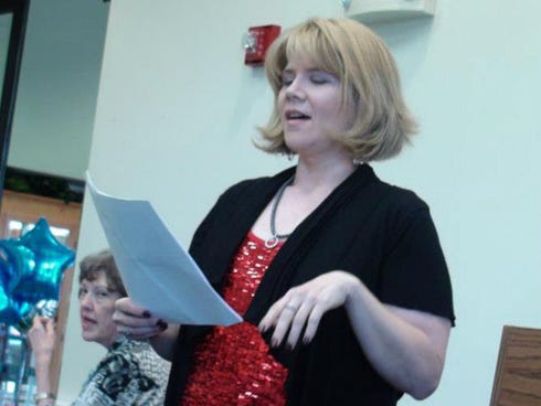 Andrea Hefner — reciting rhymes during the 2013 Poetry Slam at the Crestview Public Library — says involvement in the Poetry Club has helped her become a better writer.