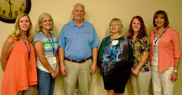 The latest Okaloosa County Master Gardeners, wearing their official badges, are pictured June 1 with Okaloosa County Extension Director Larry Williams in the Crestview office. From left are Velda Dougherty of Destin; Donna Edmiston of Mary Esther; Williams; Ada Bower of Mary Esther; Roni Graham of Crestview; and Linda Timothy of Destin.