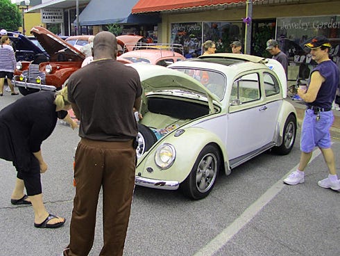 Residents admire a vintage Volkswagen sedan at the 2012 Spanish Trail Cruisers Average Joe Car Show. The annual exhibition of more than 100 pre-1979 vehicles is Saturday.