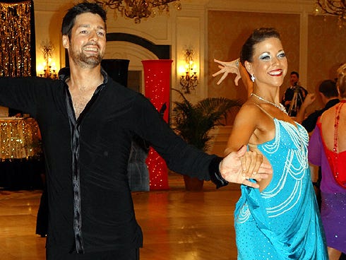 Muncelle Mitchell and her Fred Astaire studio instructor Chris Schultz dance the rumba late August during the Central Dance Championships.