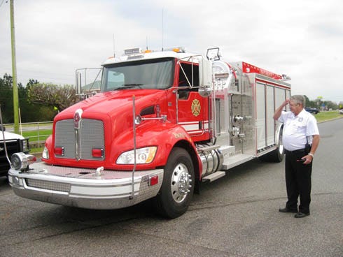 A service honoring public safety personnel and dedicating Laurel Hill's new fire truck are planned May 22 at Campton First Assembly of God, 624 State Highway 85 N. In this photo, Almarante Fire Department Chief Charles Carroll marvels at the department's new $250,000 fire truck, moments after it rolled to a stop March 10 in the Crestview Winn-Dixie parking lot.