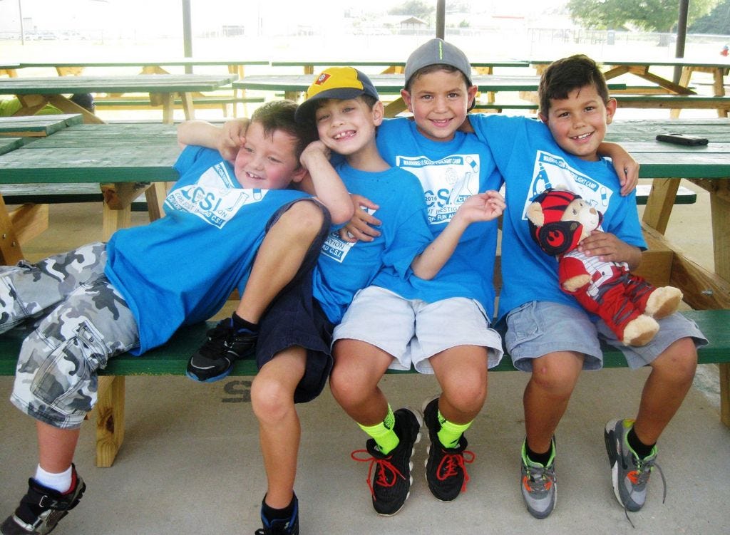 Cub Scouts from Crestview Pack 530's Wolf Den, Jacob Foster, Darrin Jaime, Nathan Dueñas and Michael Sagona, goof around for the camera during Twilight Camp in Spanish Trail Camp.