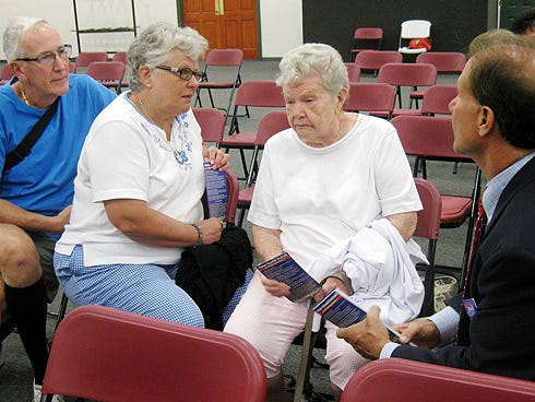 William and Marie Fortier and Marie’s aunt, Olive Avery, discuss issues with school board candidate David School prior to Thursday evening’s candidates’ forum.
