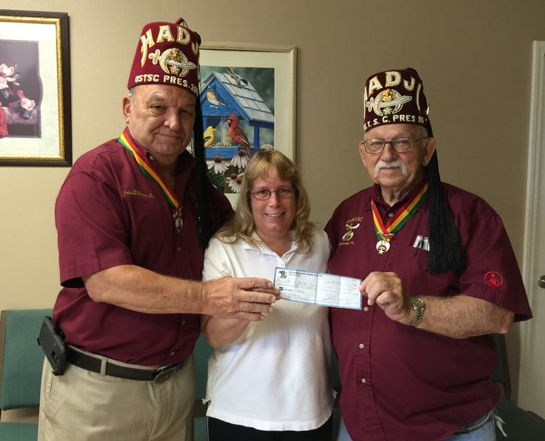 Pictured, from left, are Spanish Trail Shrine Club Vice President Johnnie Brown; Robin Marston, president of Sharing and Caring Crestview; and STSC Treasurer Robert Boutwell. (Special to the News Bulletin)