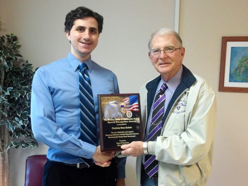 Crestview News Bulletin Editor Thomas Boni, left, accepts The Military Order of the Purple Heart's Special Recognition Award from Region IV Cmdr. Bill Everett during a recent ceremony at the newspaper's Ashley Drive office.