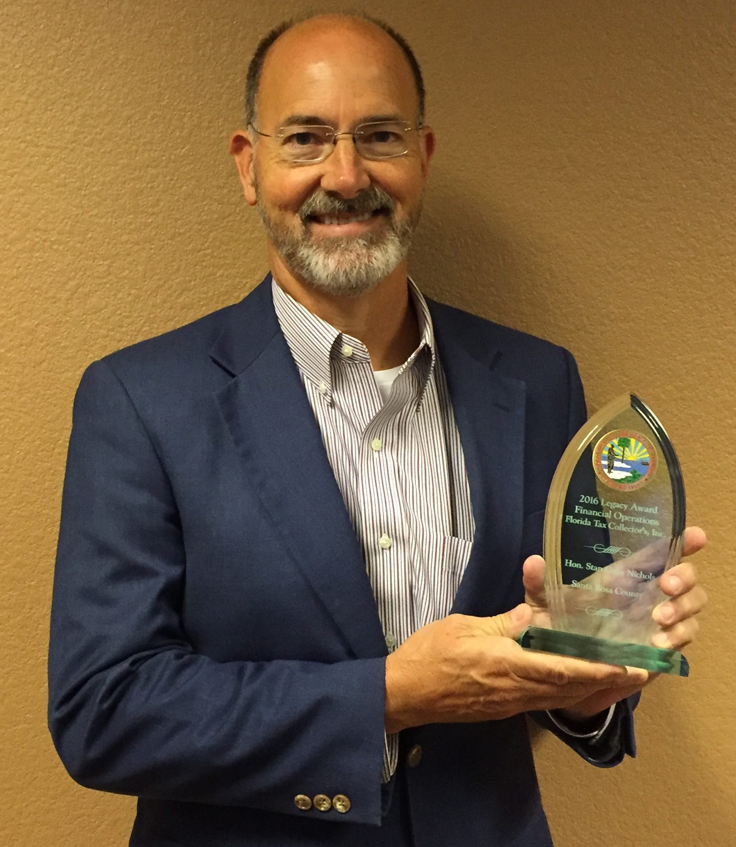 Santa Rosa County Tax Collector Stan Nichols displays his Excellence in Financial Operations Award. (Special to the Press Gazette)