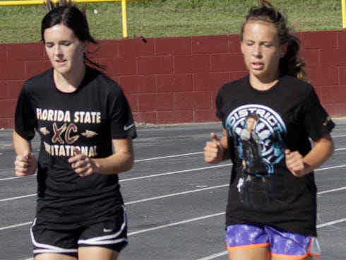 Defending district cross country champion Maya Espinosa, right, trains with her younger sister, Gabi, for Baker School's girls cross country team. The sisters are expected to make a strong showing during Thursday's District 1-1A meet at Freeport.