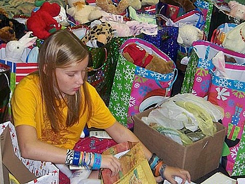 Railey Conner, 11, sorts through donations for her 12th Birthday Project. She seeks donations for nursing home residents in lieu of presents for her Dec. 15 birthday.