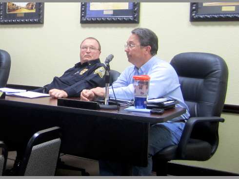 As Police Chief Tony Taylor observes, Assistant Public Works Director Carlos Jones, right, answers council members' questions about uses for a building being donated to the city.