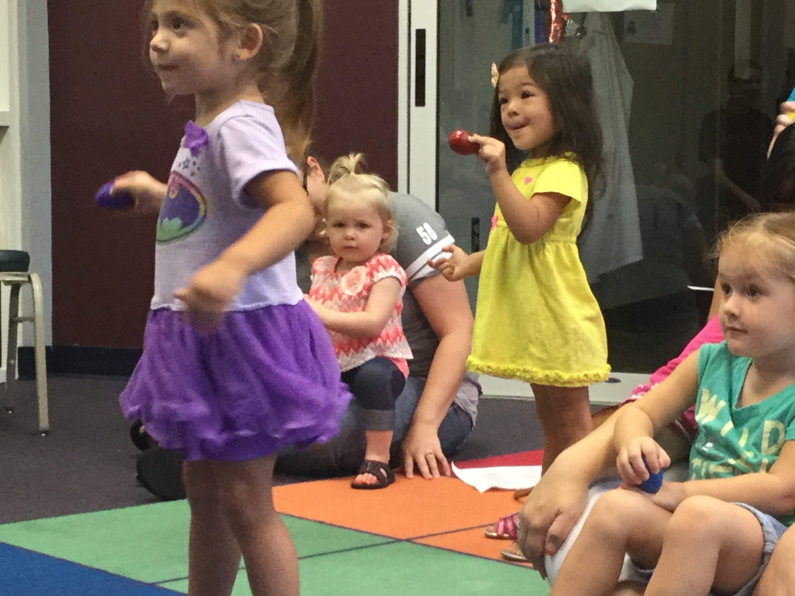 From left, Makenna Rossiter, 2; Emma Culps, 1; Aviana Krall, 2; and Scarlette Hartzell, 2, shake eggs during the Ages 0-2 Library Class Sept. 2 at the Crestview Public Library. (Special to the News Bulletin)