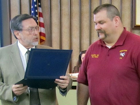 Mayor David Cadle, left, honors Battalion Chief Tony Holland as Firefighter of the Year.