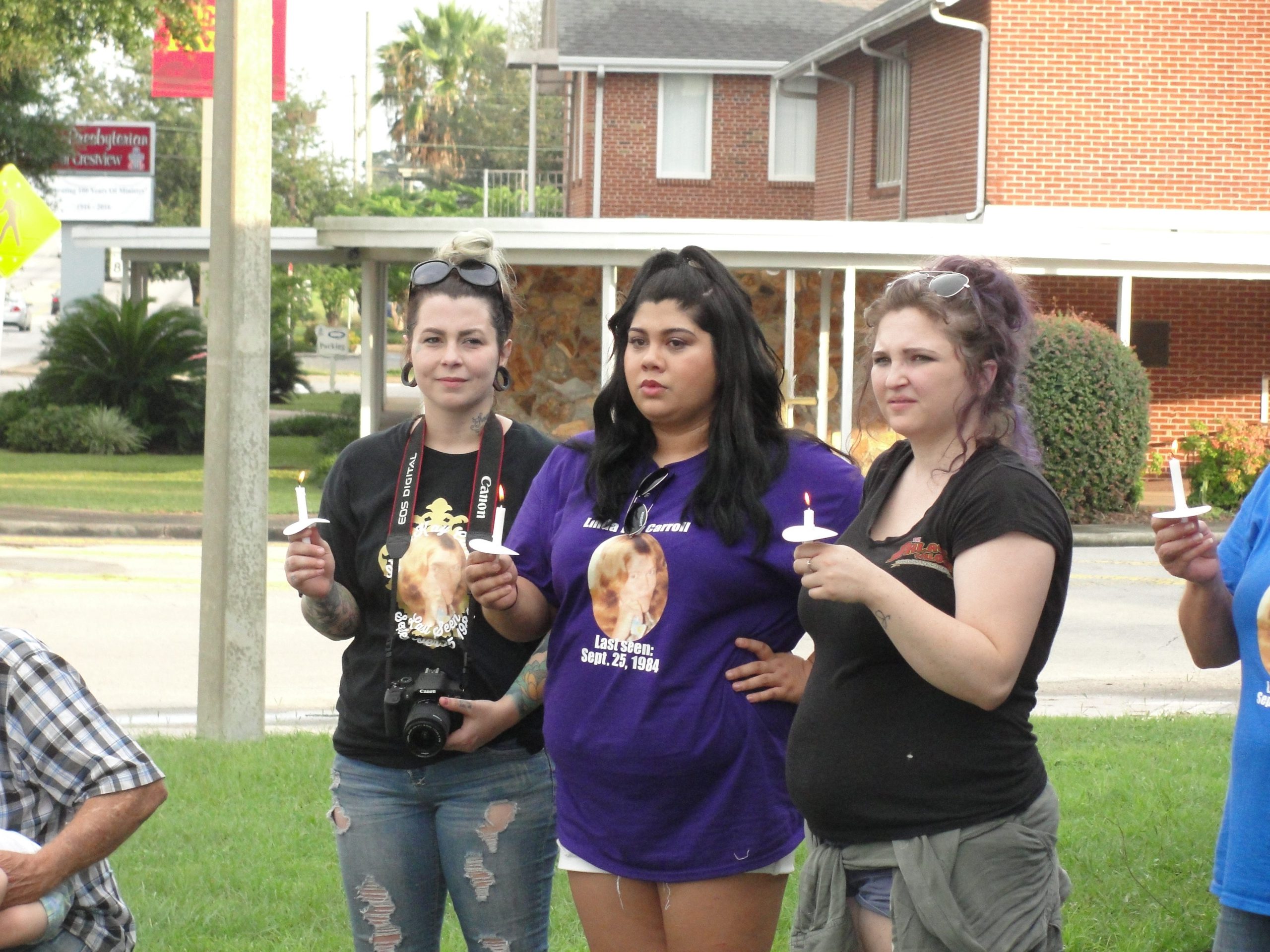 Supporters light candles in memory of Linda Kay Carroll and Chip Campbell. SAMANTHA LAMBERT | News Bulletin