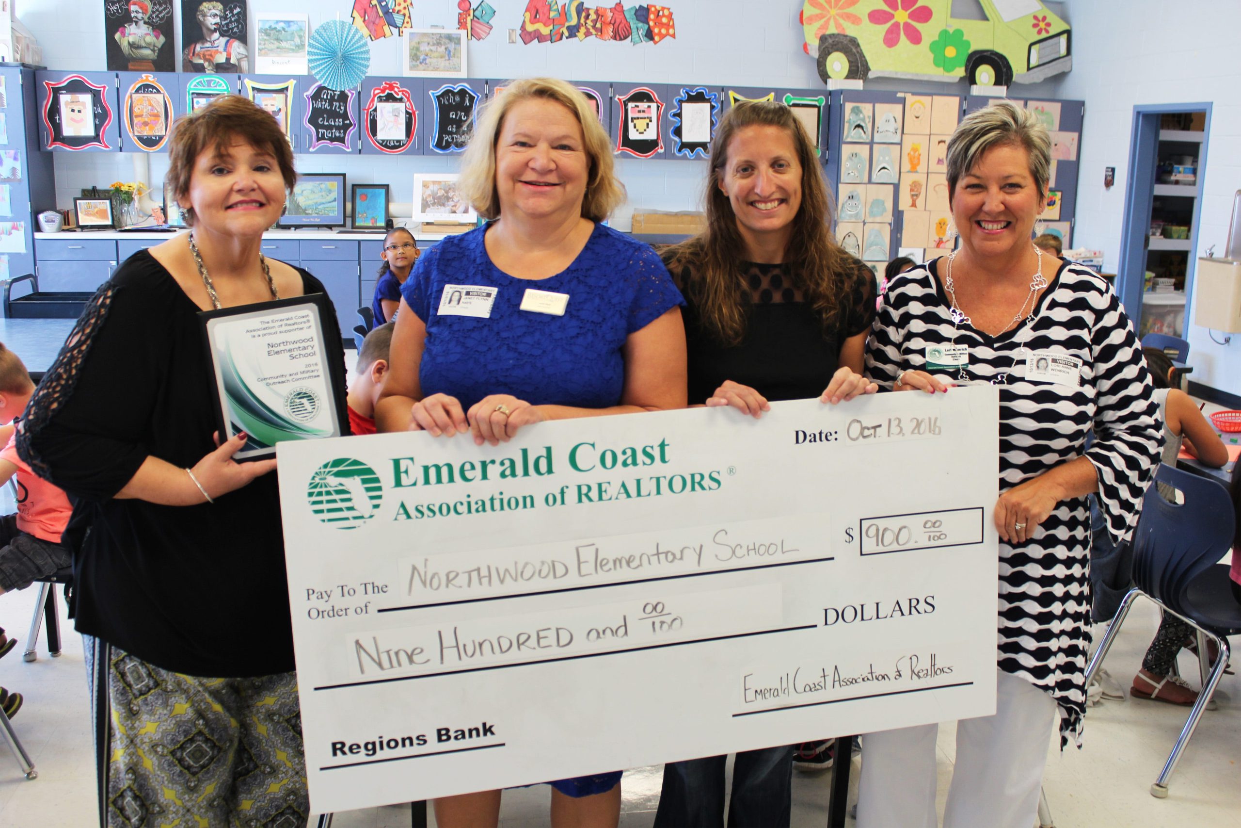 Northwood Elementary School Principal Dr. Donna Goode, Janet Hays, Beth Plantz and Lori Wenrich display a $900 check from the Emerald Coast Association of Realtors. (Special to the News Bulletin)