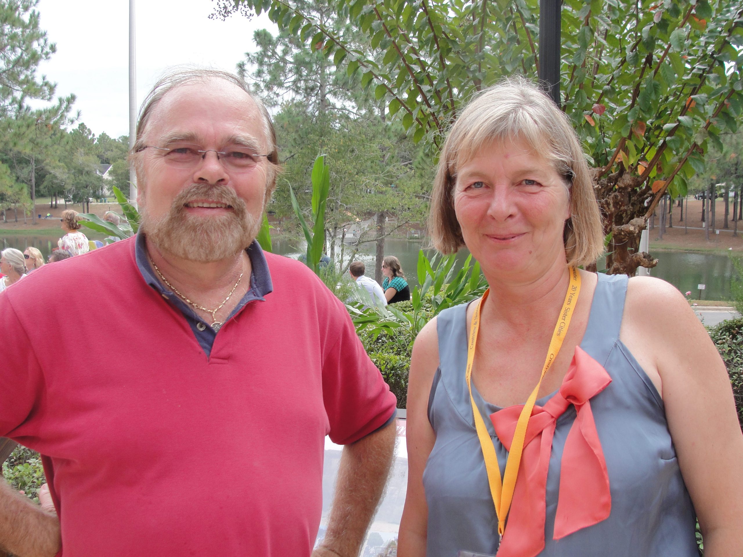 Host family member Dan Bears visits with French journalist Benedicte Lerman during the garden dedication. (SAMANTHA LAMBERT | News Bulletin)
