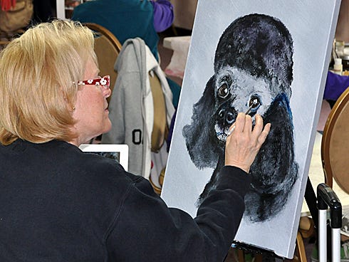 Bettye Keefer uses oil paint to create the poodle, "GiGi," in her masterpiece.