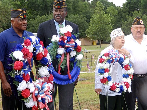 Representatives of the American Legion in Crestview stand with wreaths they presented Monday during a Memorial Day observance at Live Oak Memorial Park.