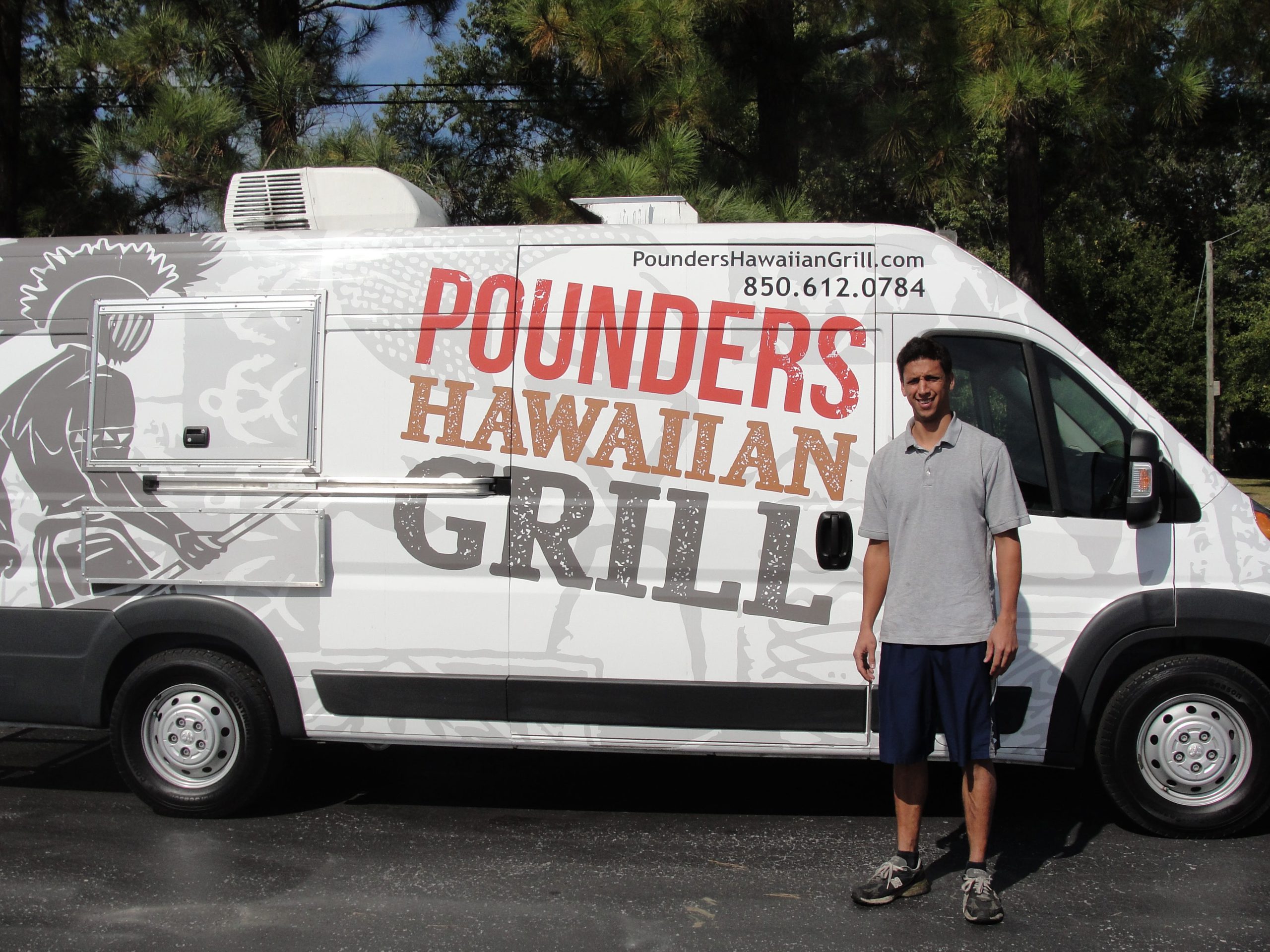 Kakela Peters, Crestview native and owner of Pounders Hawaiian Grill, stands in front of his food truck. (SAMANTHA LAMBERT | News Bulletin)