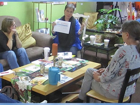 The Crestview Area Chamber of Commerce’s Arts and Culture Committee members listen as Chairperson Rae Schwartz, center, discusses upcoming plans.