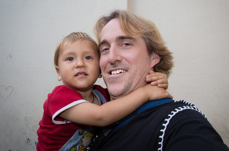 A child at an orphanage hugs Russell Wells at an orphanage in Machala, Ecuador in 2014. "What you don't see are the three other kids pulling on me to pick them up, all while I'm holding onto this one and using my full-sized SLR camera for a selfie. That's a hard trick; the children are incredibly lonely and the facilities are sparse. The unseen barbed wire surrounding the compound is to keep the human trafficking predators out," Wells said of the photo. Russell L. Wells | Special to the News Bulletin