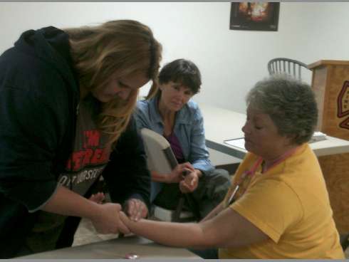 Crestview Emergency Response Team member Cynthia Hall, center, watches as CERT member Lisa Rhodes checks Dawn Rodriguez's pulse during a November firefighter rehabilitation training exercise at Crestview Fire Station 1.