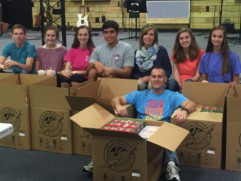 Christian Watkins, Zoe Carr, Haleigh Butryn, Oscar Rojas, April Butryn, Pastor Joe Butryn, Katie King and Marissa Butryn, from left, are some of the Joy Fellowship Senior High Youth Group members who volunteered to help pack OCC shoeboxes. Special to the News Bulletin