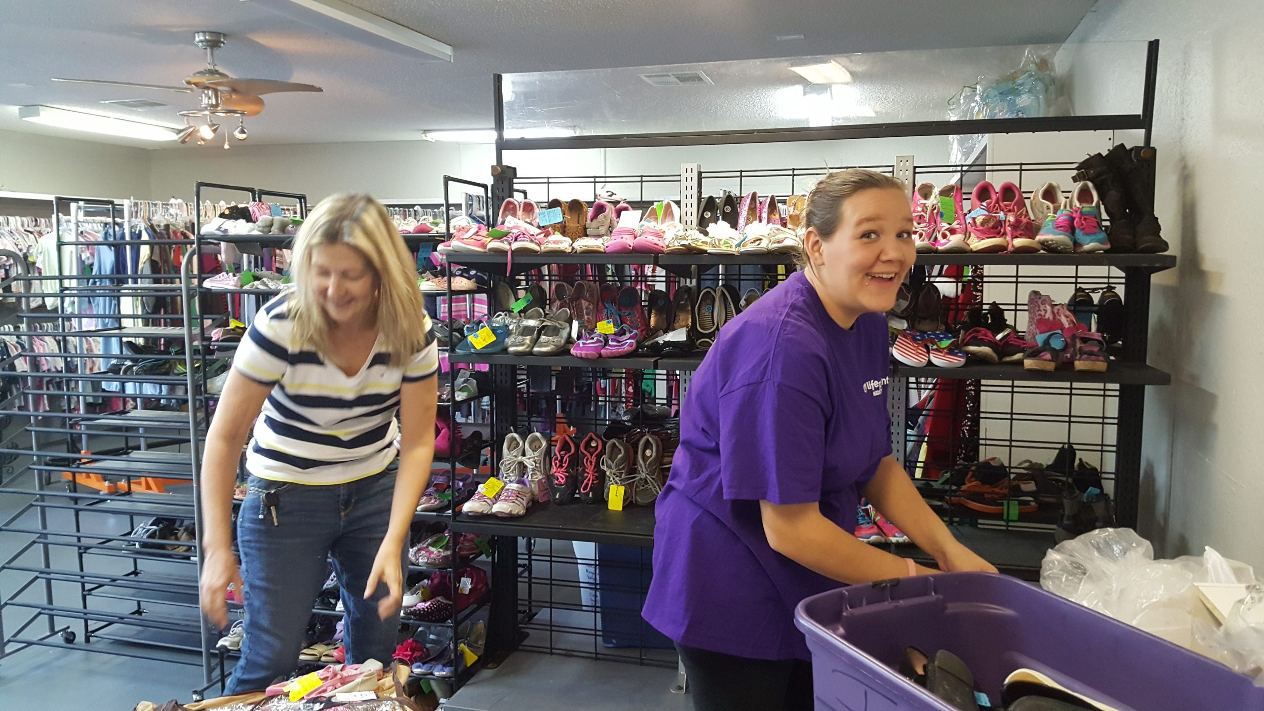 Linda Samper and Amber Fairchild place children's shoes for display. (Special to the News Bulletin)