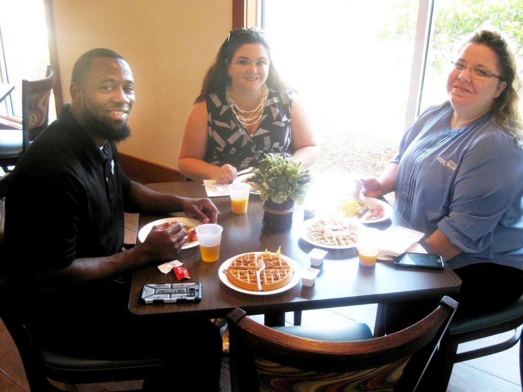Heather Graf of Wells Fargo, center, joins Chris Washington and Erika Linnan of Cox Communications during National Waffle Day breakfast at the Crestview Comfort Inn.