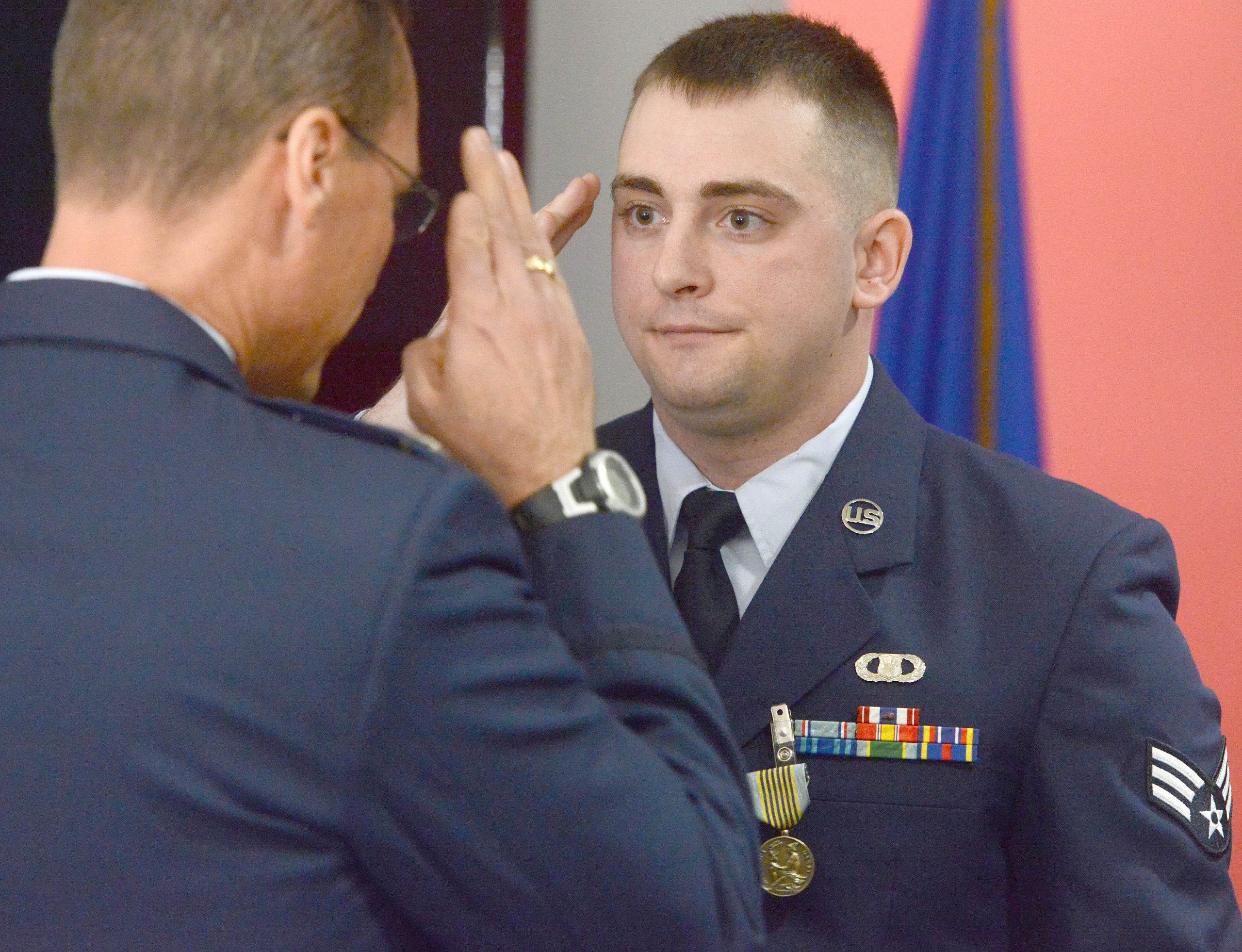 Senior Airman Justin Barabash of the 1st Special Operations Support Squadron, salutes Col. Thomas Palenske, Commander of the 1st Special Operations Wing during a ceremony on Friday at Hurlburt Field, where Barabash was awarded the Airman's Medal for pulling a woman out of a burning car in Fort Walton Beach in 2014. The Airman's Medal is the highest non-combat medal an Airman can receive. NICK TOMECEK/DAILY NEWS