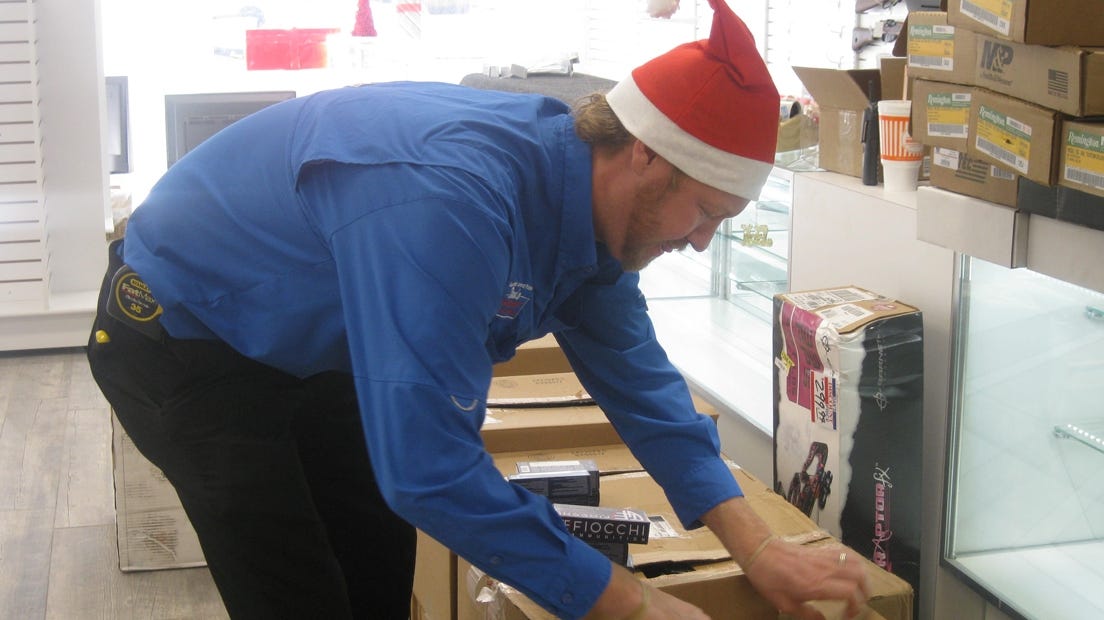 Owner Bryce Jeter unpacks ammunition for the firearms section of Dan's Discount Jewelry & Pawn Dec. 1 in Crestview. Renee Bell | News Bulletin