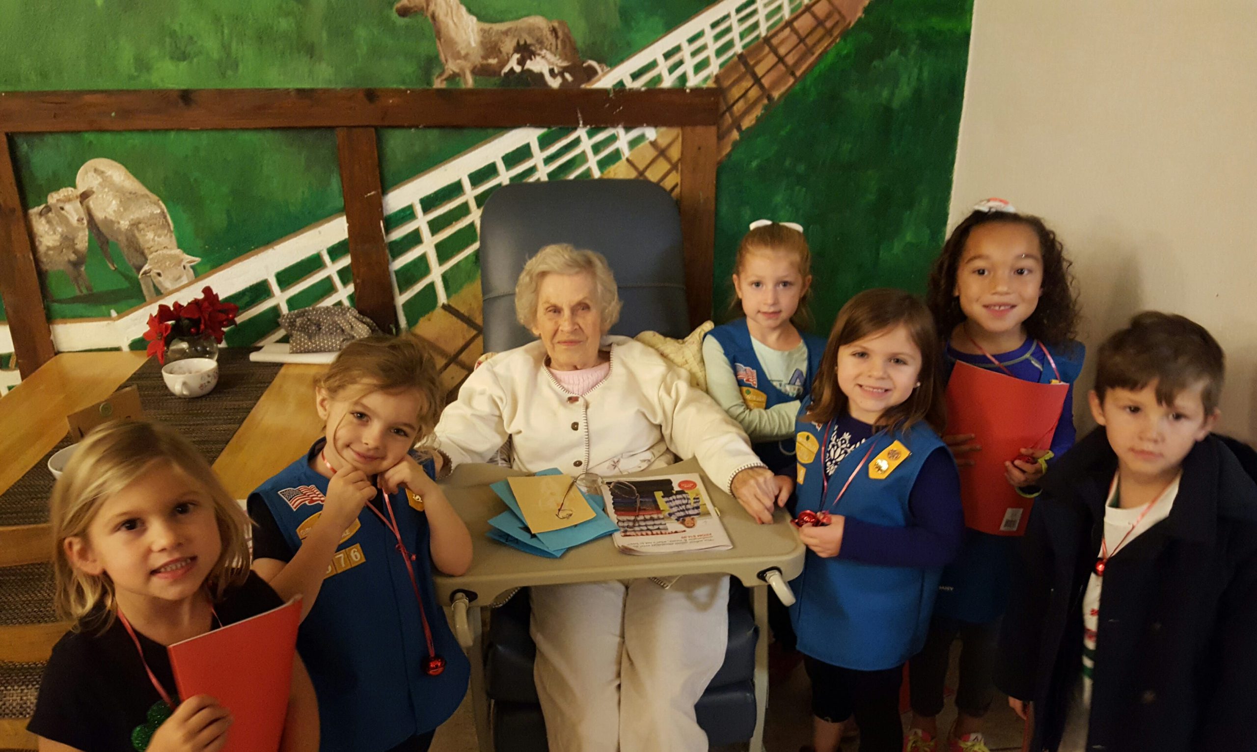 Pictured, from left, are Girl Scout Troop 676 members Gianna Finnegan, Temperance Brindle, Ainsley Gardner, Avery Gagne, Brooklynn Barber and Julian Gallegos with Crestview Manor resident Millie Biondi. (Special to the News Bulletin)