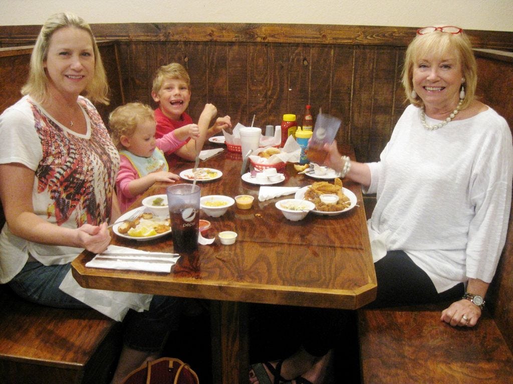 Mary Richard, right, enjoys a dinner Wednesday evening with her daughter, Bridget Krebs, and grandchildren, Katherine Krebs, 2, and Paul Richard, 7, at Wayne's Catfish House in Crestview.
