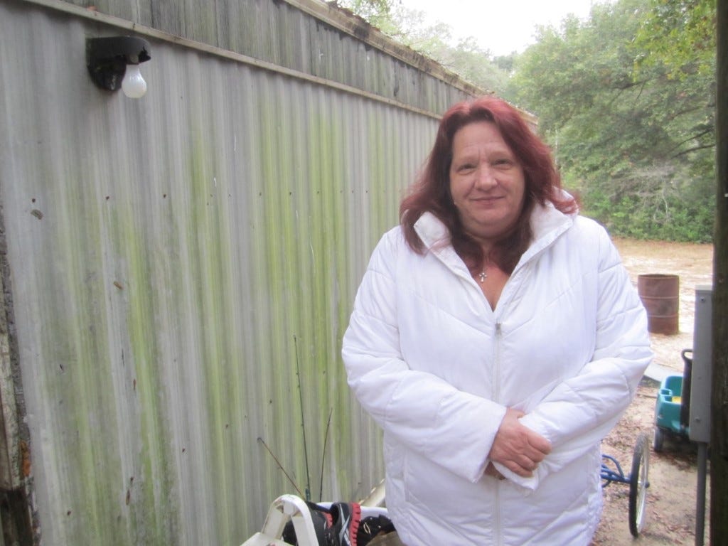 Debbie Campione stands on the deck of a Lee Avenue mobile home she and her family recently vacated when the property was sold.