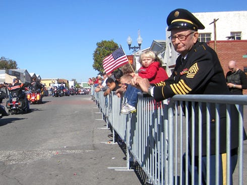 Retired 1st Sgt. George Ballard, still wearing his Army dress blues after 33 years of retirement, watches the Crestview Veterans Day Parade.