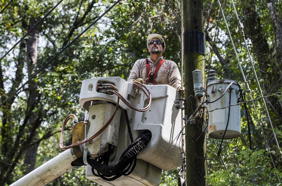 A Gulf Power Company employee assists with recovery from Hurricane Hermine Sept. 5 in Tallahassee. The company will lower its rates in January. Colin Hackley |Special to the News Bulletin