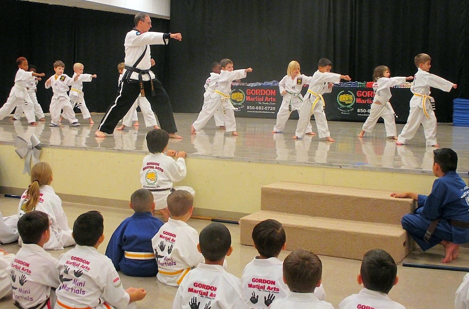 Gordon Martial Arts instructor Greg Bledsoe puts Mini Martials students between 4 and 6 years old through a form, or routine, during the academy's Jan. 6 belt ceremony. Brian Hughes | Special to the News Bulletin
